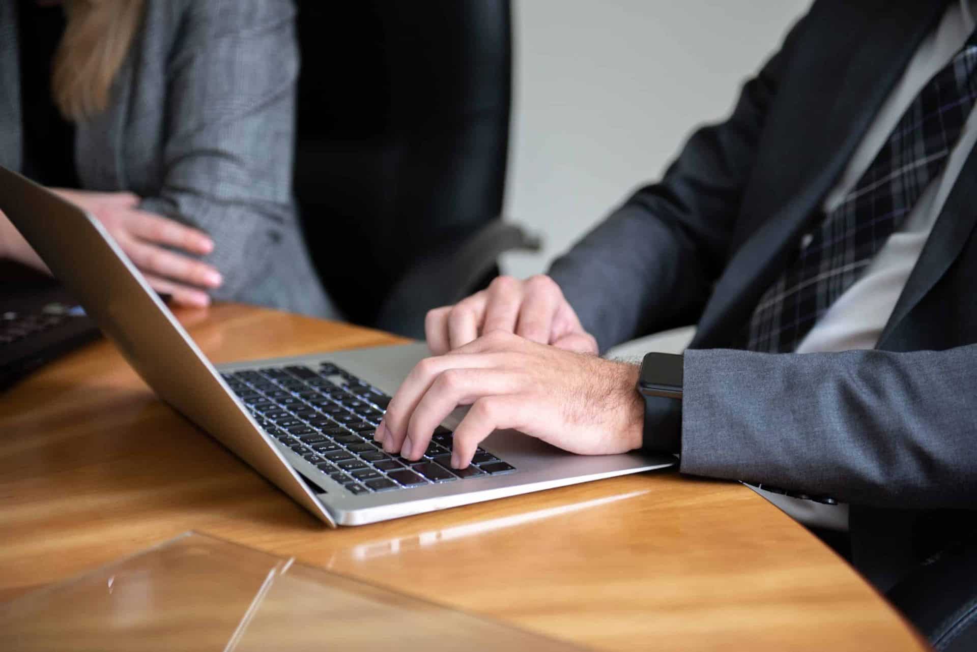business meeting close up of hands on a computer