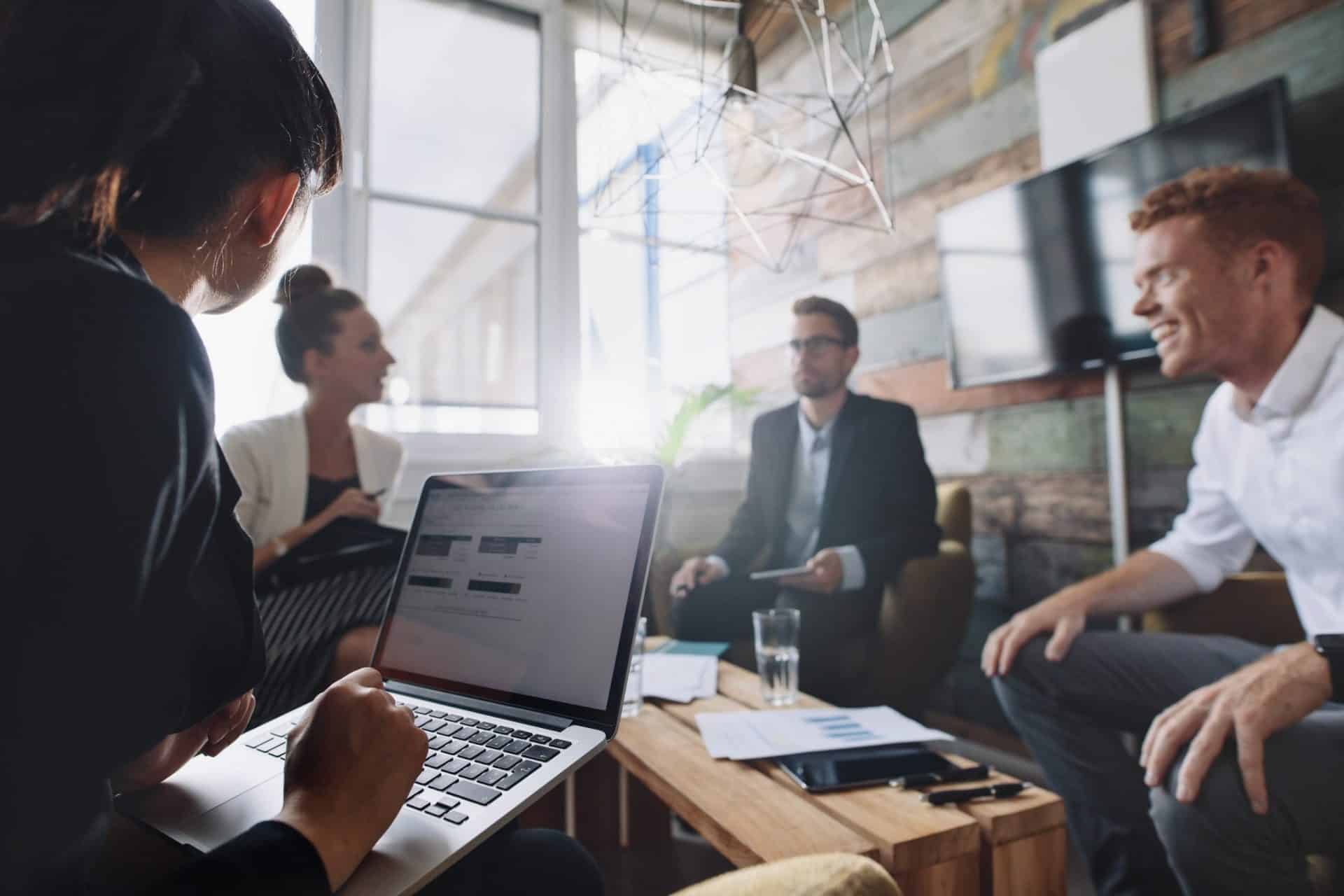 business woman working on laptop while having a meeting