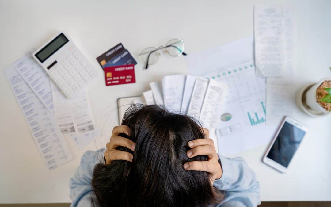 stressed female looking over her financial paperwork